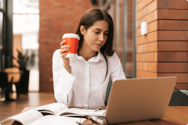 brunette-woman-drinking-coffee-to-go-while-working-2022-01-18-23-32-14-utc